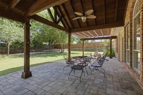 a view of a porch with chairs and backyard