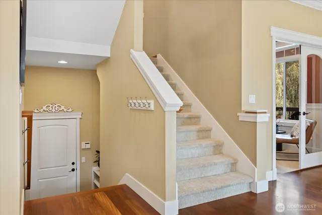 a view of entryway and hall with wooden floor