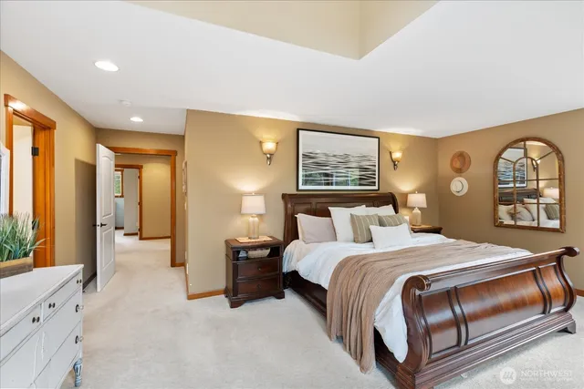 a bedroom with a large bed and a chandelier