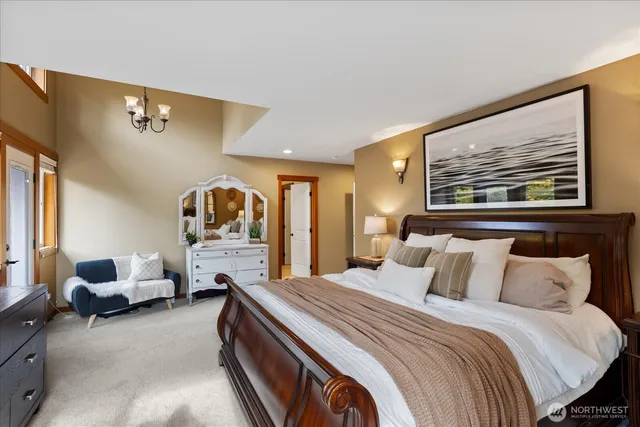 a bed room with a bed and a painting on the wall