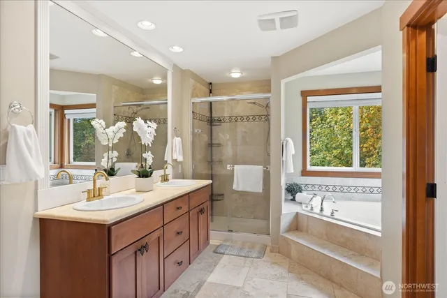 a bathroom with a double vanity sink and a bathtub