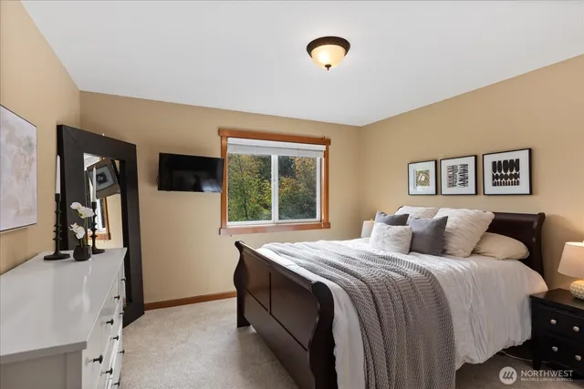 a bedroom with a bed and a large mirror