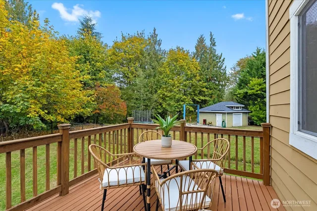 a view of a balcony with a table and chairs