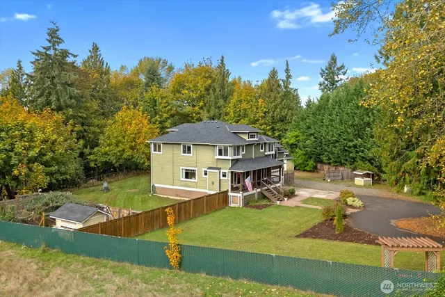 a view of a house with swimming pool next to a yard