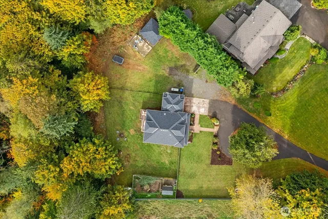 an aerial view of a house with a yard
