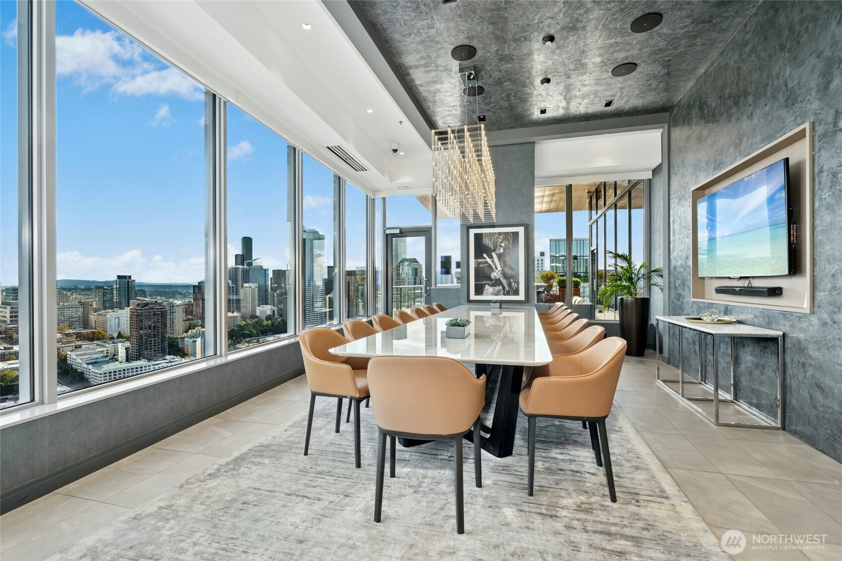 1808 Minor Avenue, Unit 3213 Seattle, WA 98101 - Photo 29 of 40 a dining room with furniture a flat screen tv and a floor to ceiling window