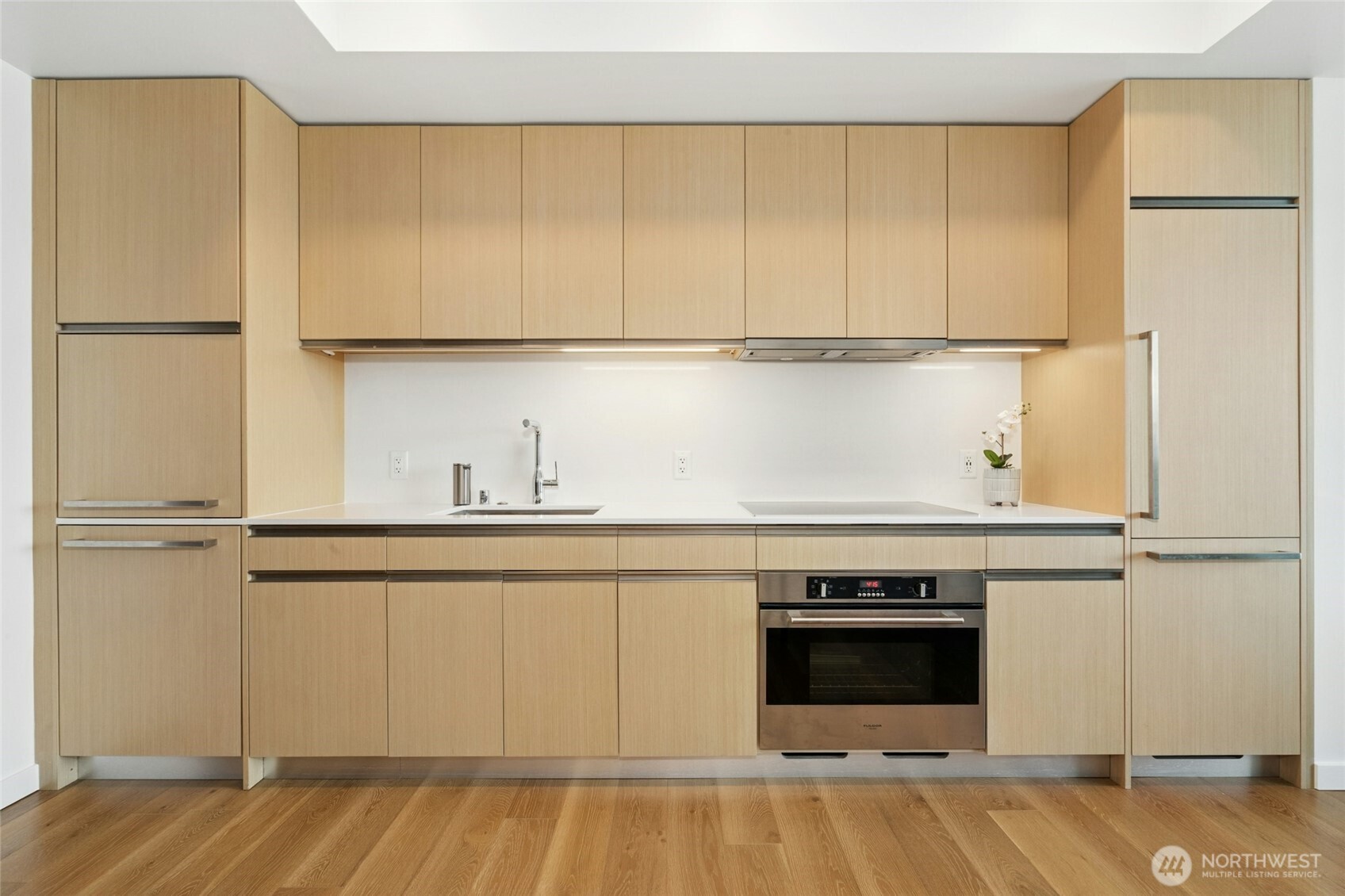 1808 Minor Avenue, Unit 3213 Seattle, WA 98101 - Photo 9 of 40 a view of a kitchen with a sink wooden floor and a window