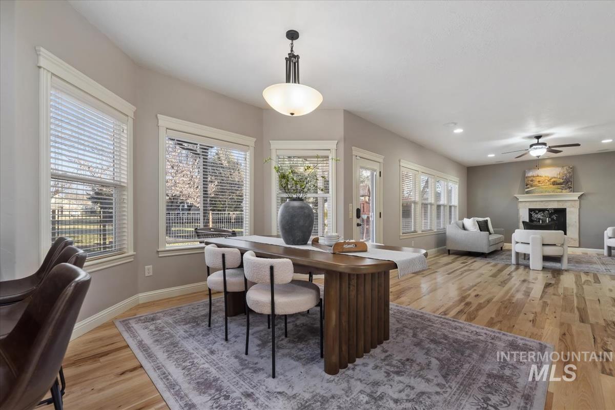 1082 East Azan Street Meridian, ID 83646 - Photo 11 of 47 Office space featuring a fireplace, light wood-type flooring, and a ceiling fan