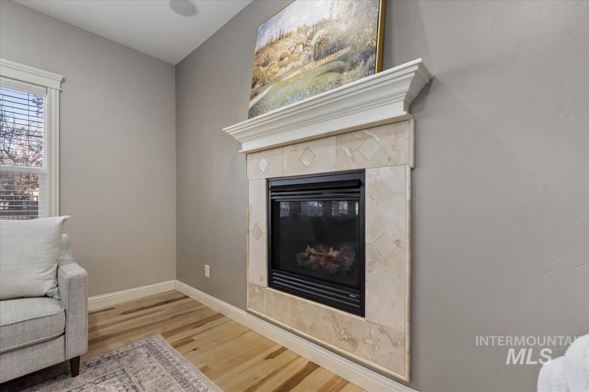 1082 East Azan Street Meridian, ID 83646 - Photo 13 of 47 Living area featuring a tiled fireplace and wood finished floors