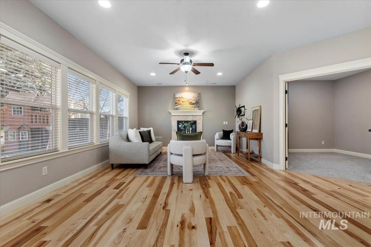 1082 East Azan Street Meridian, ID 83646 - Photo 16 of 47 Living area featuring a fireplace, ceiling fan, recessed lighting, and light wood-style flooring