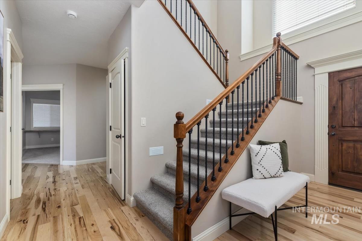 1082 East Azan Street Meridian, ID 83646 - Photo 21 of 47 Stairs featuring wood finished floors and a high ceiling