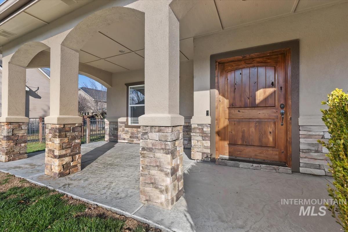 1082 East Azan Street Meridian, ID 83646 - Photo 3 of 47 View of exterior entry with stucco siding and stone siding