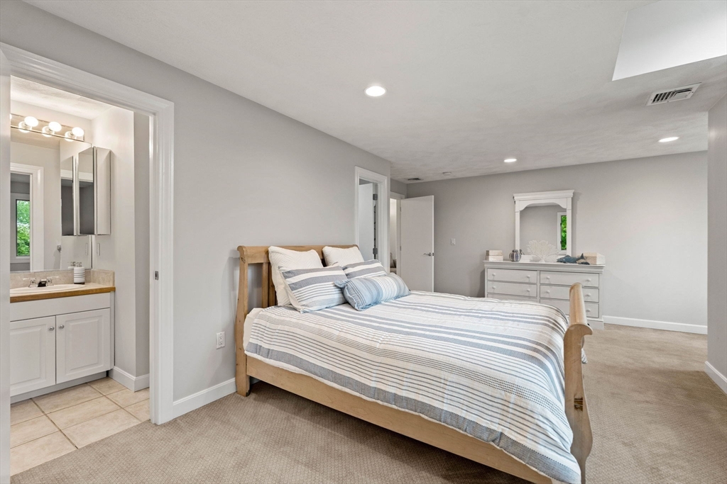 53 Gerald Road Marblehead, MA 01945 - Photo 24 of 42 a bedroom with a bed and a chandelier
