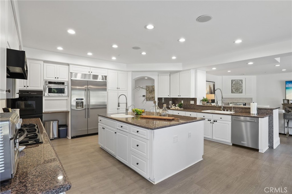 2 Olympic Way Coto de Caza, CA 92679 - Photo 12 of 75 a kitchen with appliances a sink and a counter top space