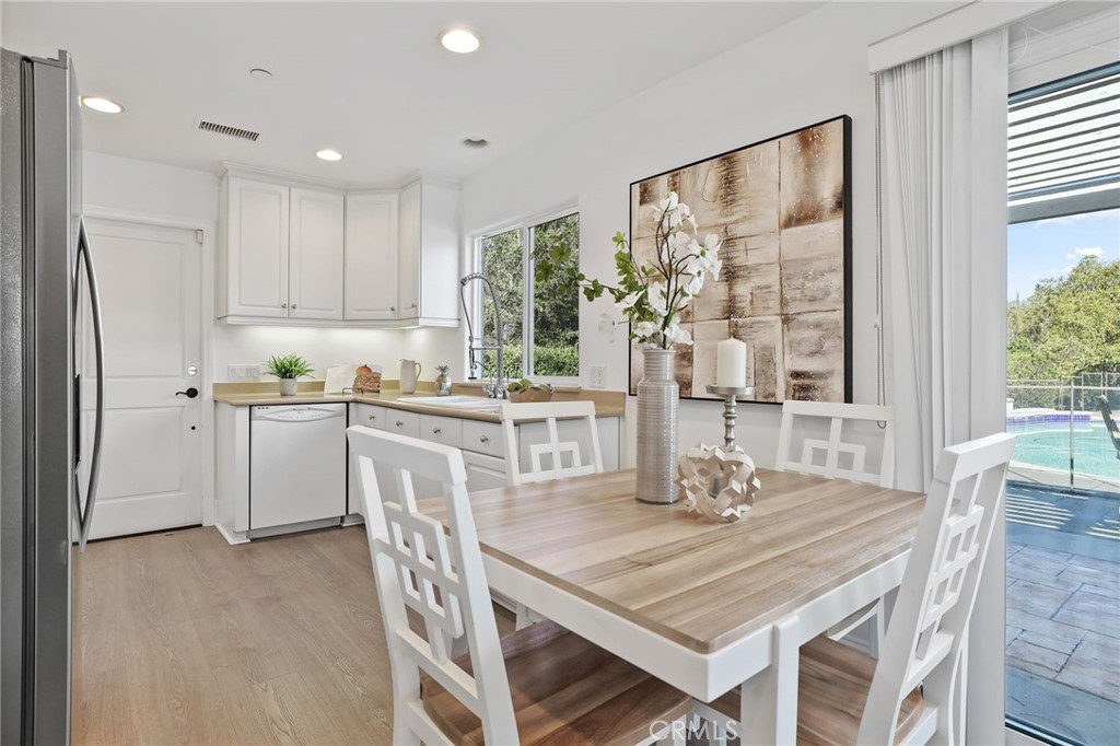 2 Olympic Way Coto de Caza, CA 92679 - Photo 57 of 75 a kitchen with stainless steel appliances granite countertop a stove a refrigerator a kitchen island a table and chairs