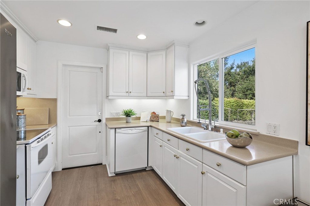 2 Olympic Way Coto de Caza, CA 92679 - Photo 58 of 75 a kitchen with a sink cabinets appliances and a window