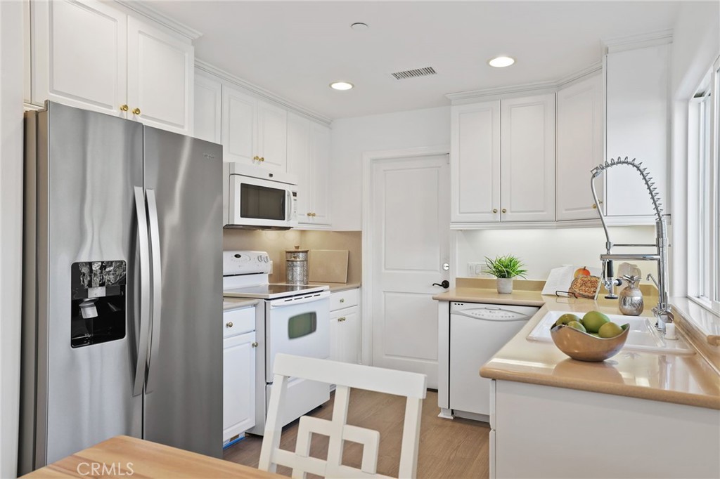 2 Olympic Way Coto de Caza, CA 92679 - Photo 59 of 75 a kitchen with stainless steel appliances granite countertop a refrigerator sink and stove