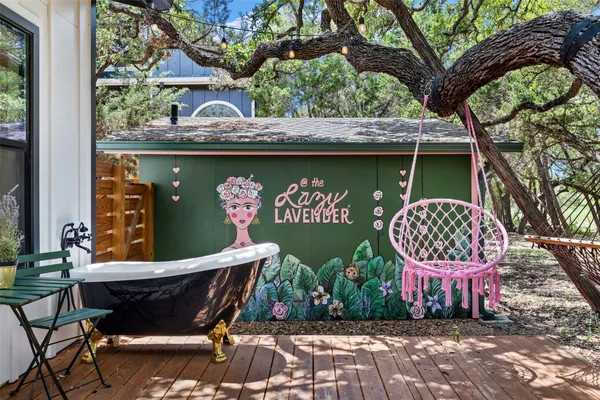 a view of a chairs and table in a back yard