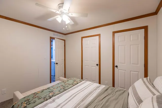 a bedroom with a bed and a chandelier