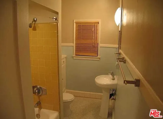 a kitchen with a stove a refrigerator and a microwave