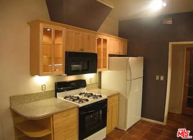 a kitchen with a sink stove and refrigerator