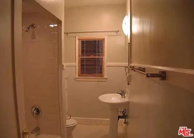a bathroom with a shower and a glass door