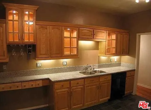 a kitchen with stainless steel appliances granite countertop a stove a refrigerator and a microwave oven
