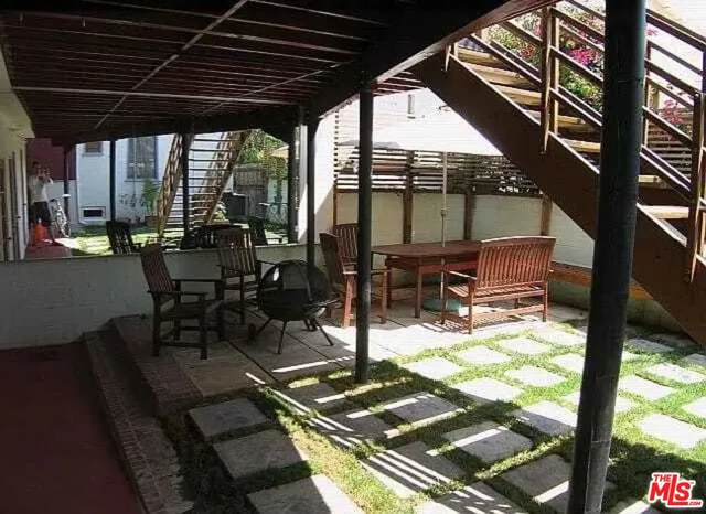 a view of a house with backyard and wooden floor