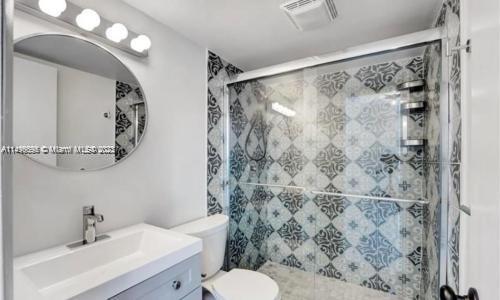 665 Enfield Street, Unit B8 Boca Raton, FL 33487 - Photo 6 of 10 a bathroom with a sink toilet and shower