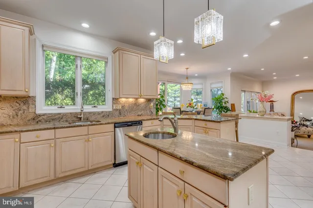 a kitchen with stainless steel appliances kitchen island granite countertop a refrigerator and microwave