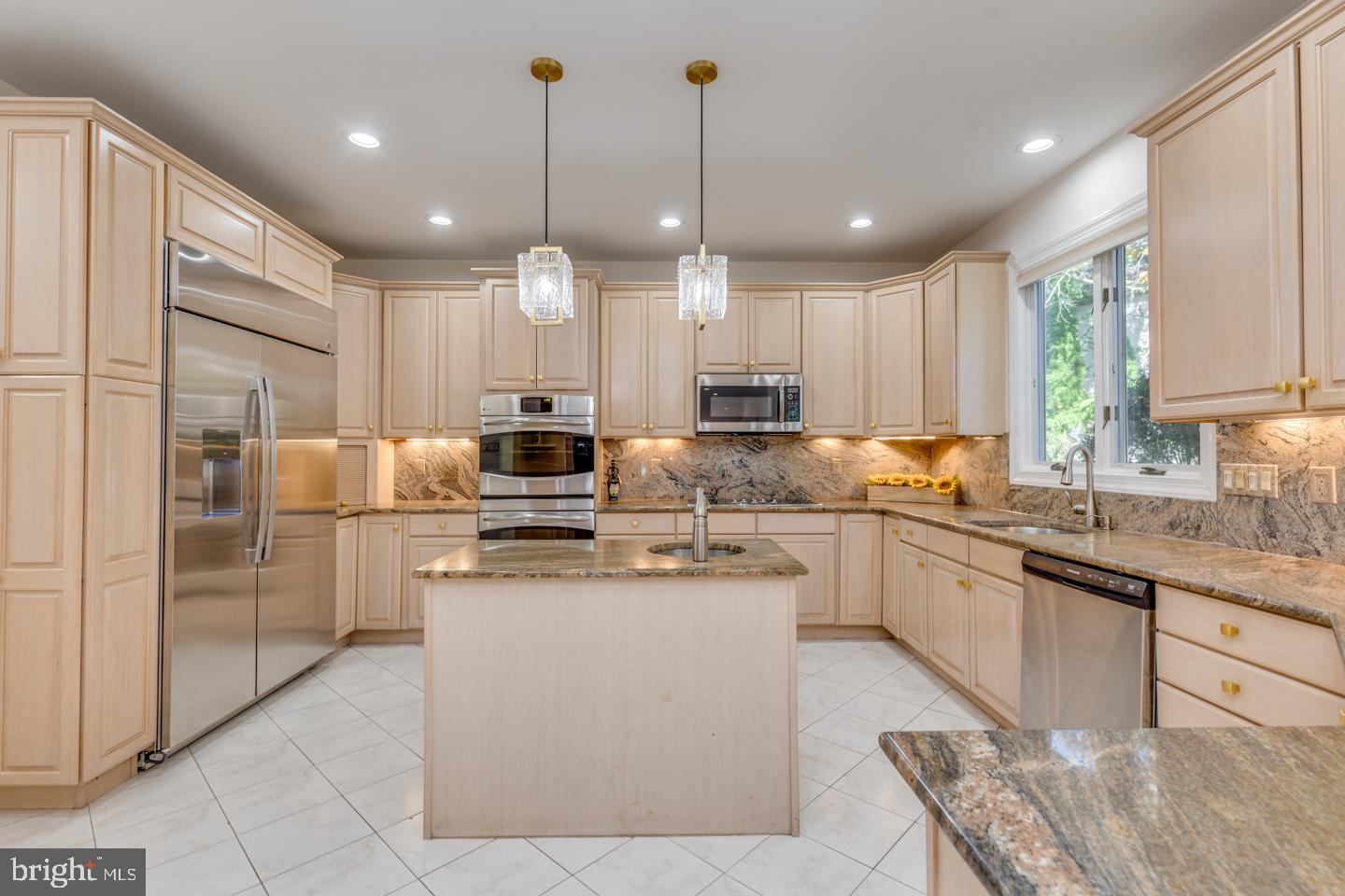 2 Collage Court Cherry Hill, NJ 08003 - Photo 17 of 89 a kitchen with stainless steel appliances granite countertop a sink a stove a refrigerator and island with wooden floor