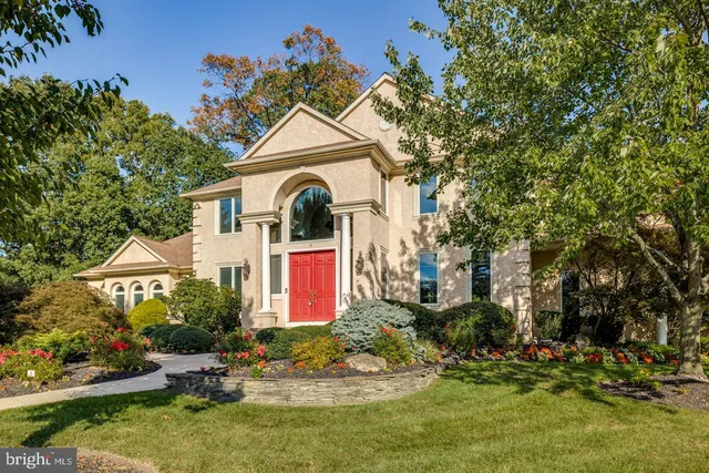 a front view of a house with a yard and fountain