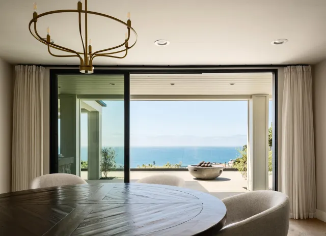 a bedroom with furniture and a floor to ceiling window