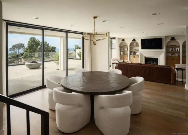 a dining room with furniture and wooden floor