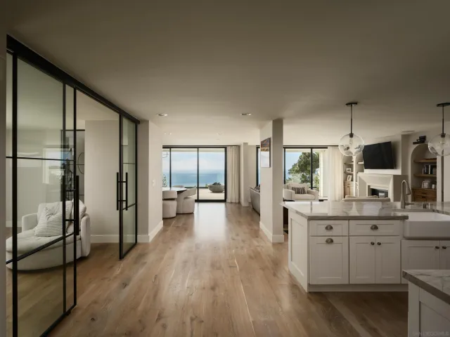 a kitchen with stainless steel appliances a refrigerator and wooden floor