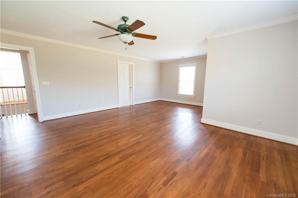 484 Pierce Road Landrum, SC 29356 - Photo 11 of 35 an empty room with wooden floor and windows