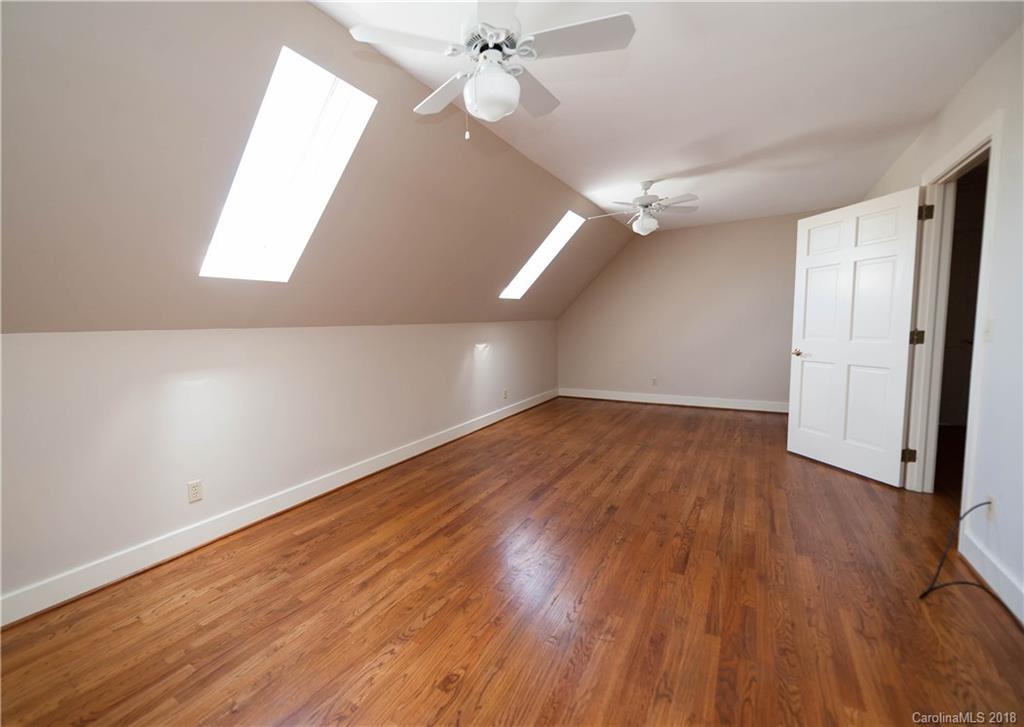 484 Pierce Road Landrum, SC 29356 - Photo 14 of 35 an empty room with wooden floor fan and windows