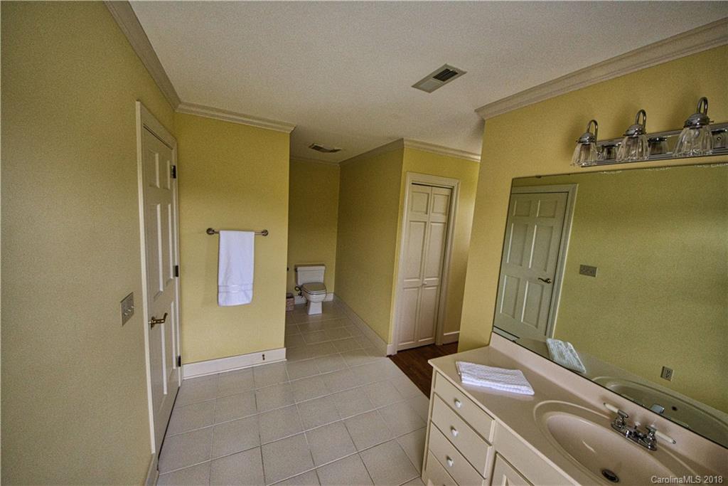 484 Pierce Road Landrum, SC 29356 - Photo 16 of 35 a bathroom with a granite countertop sink toilet and shower