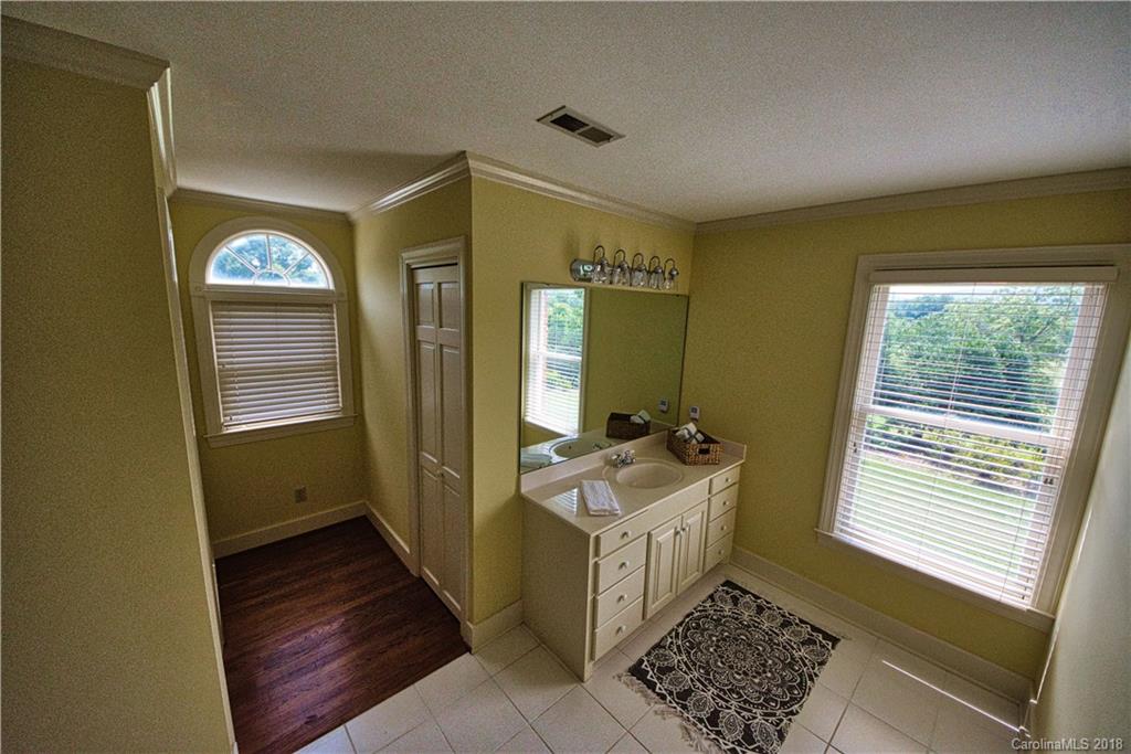 484 Pierce Road Landrum, SC 29356 - Photo 17 of 35 a bathroom with a sink a mirror and a bathtub