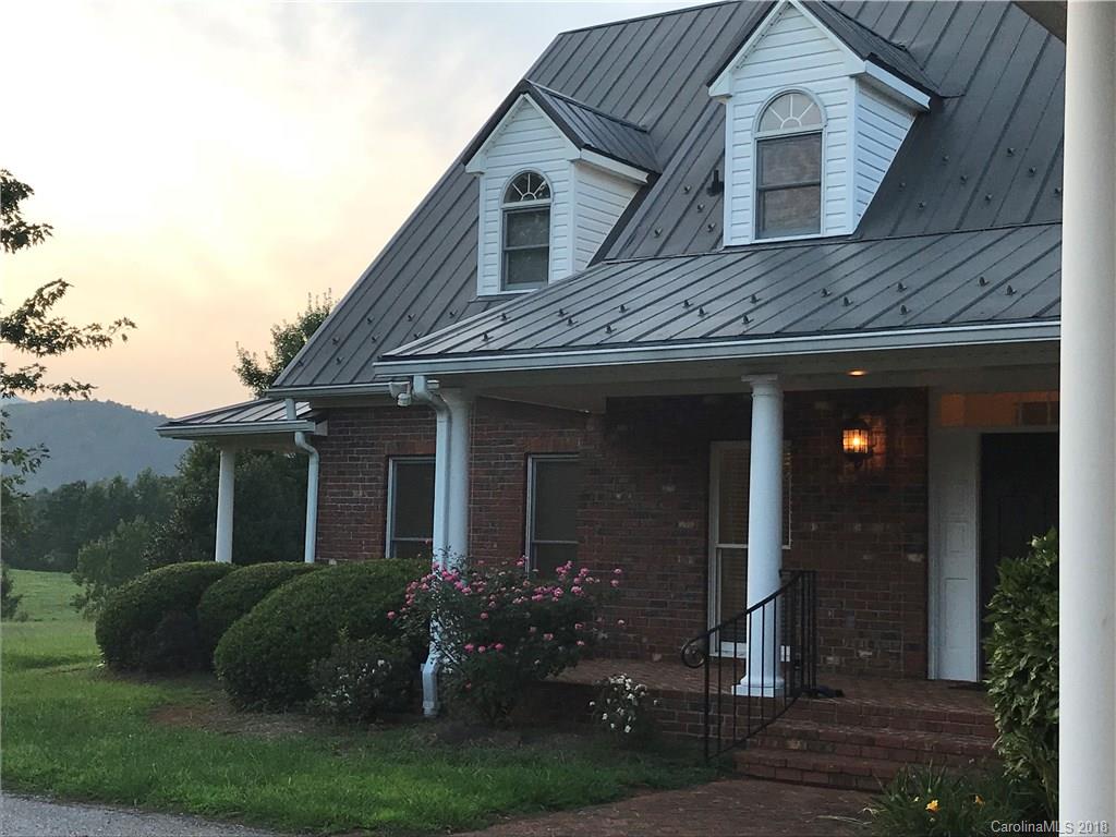 484 Pierce Road Landrum, SC 29356 - Photo 19 of 35 a front view of a house with garden