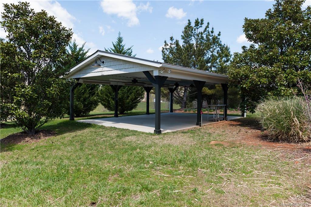 484 Pierce Road Landrum, SC 29356 - Photo 25 of 35 a view of a table and chairs under an umbrella
