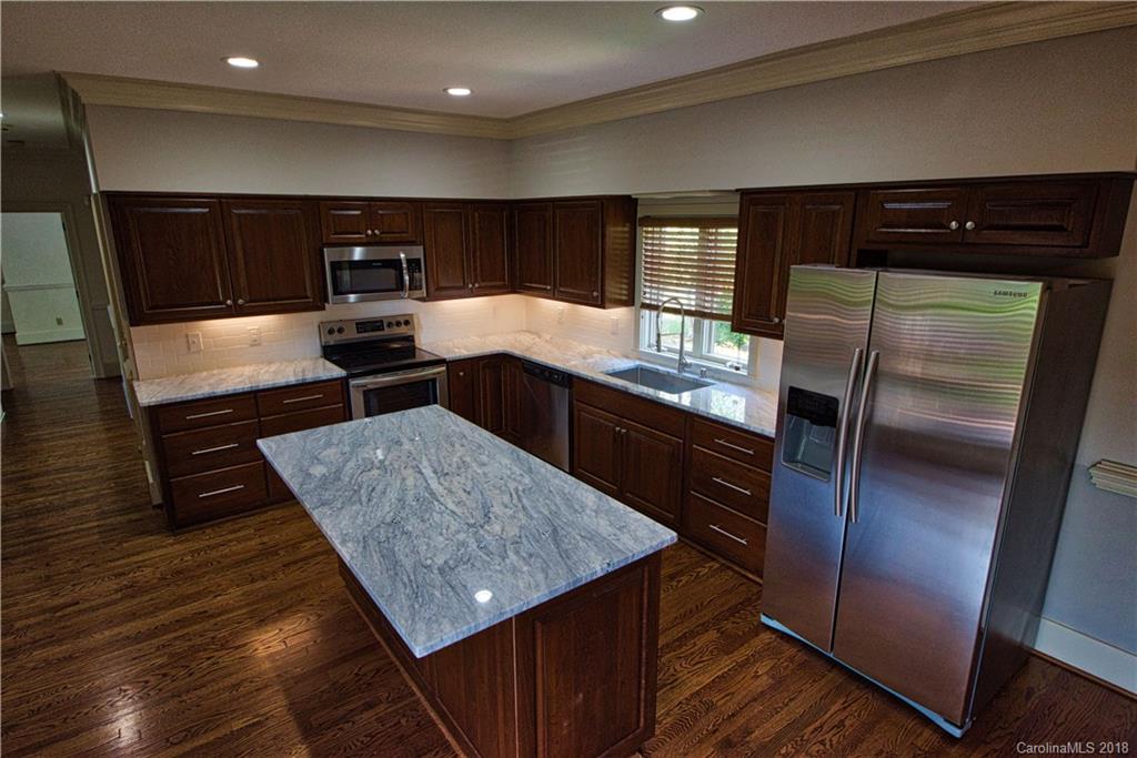 484 Pierce Road Landrum, SC 29356 - Photo 5 of 35 a kitchen with stainless steel appliances kitchen island granite countertop a refrigerator and a sink