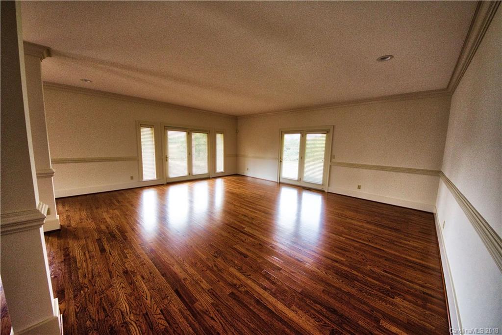 484 Pierce Road Landrum, SC 29356 - Photo 7 of 35 a view of an empty room with wooden floor and a window