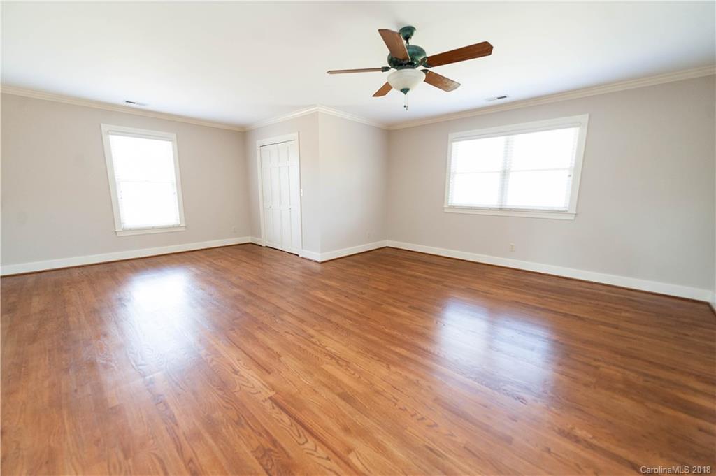 484 Pierce Road Landrum, SC 29356 - Photo 10 of 35 a view of an empty room with wooden floor and a window