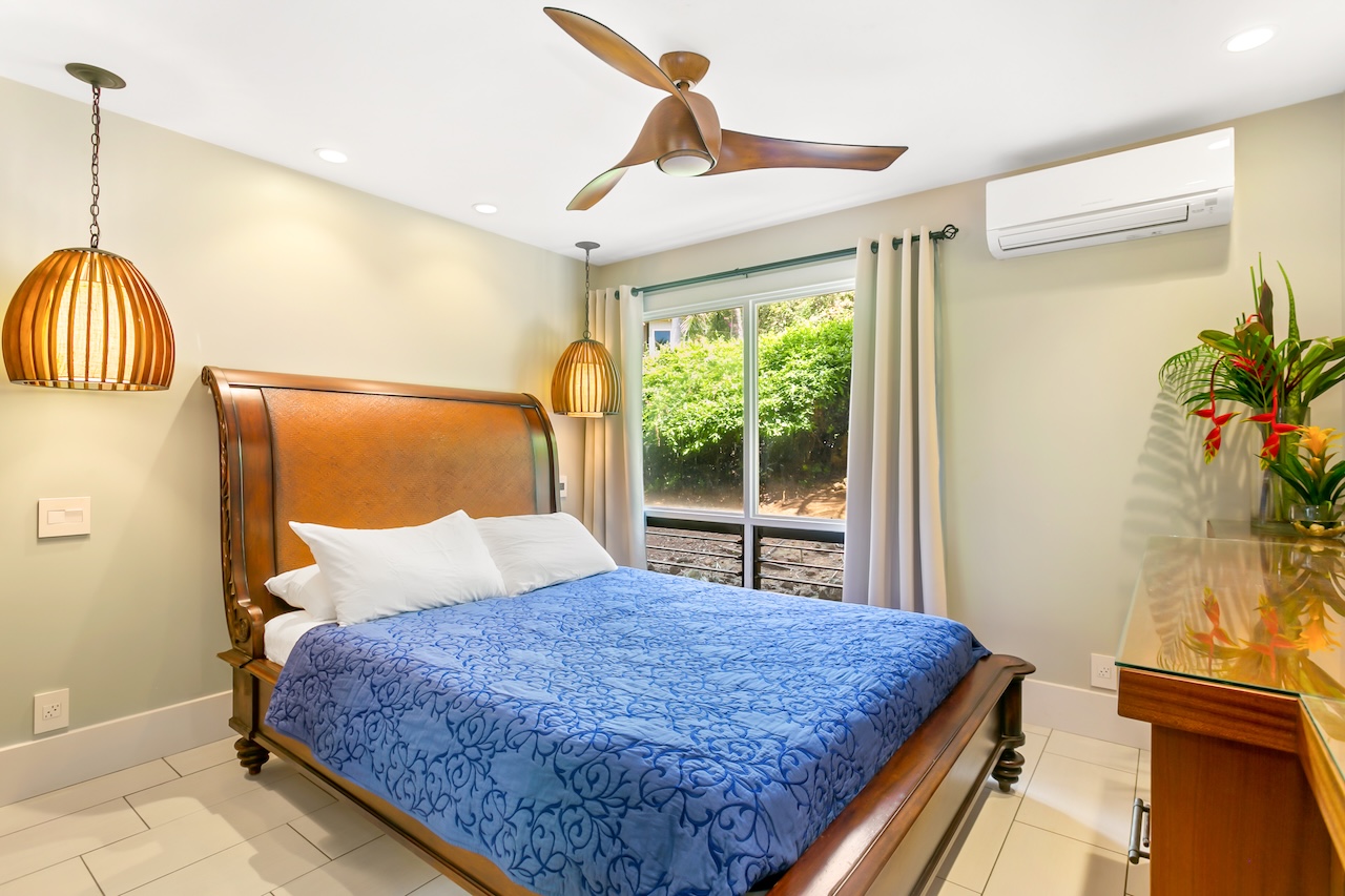 2330 Ho'ohu Road, Unit 16 Koloa, HI 96756 - Photo 15 of 29 a bedroom with a bed and a window with potted plants