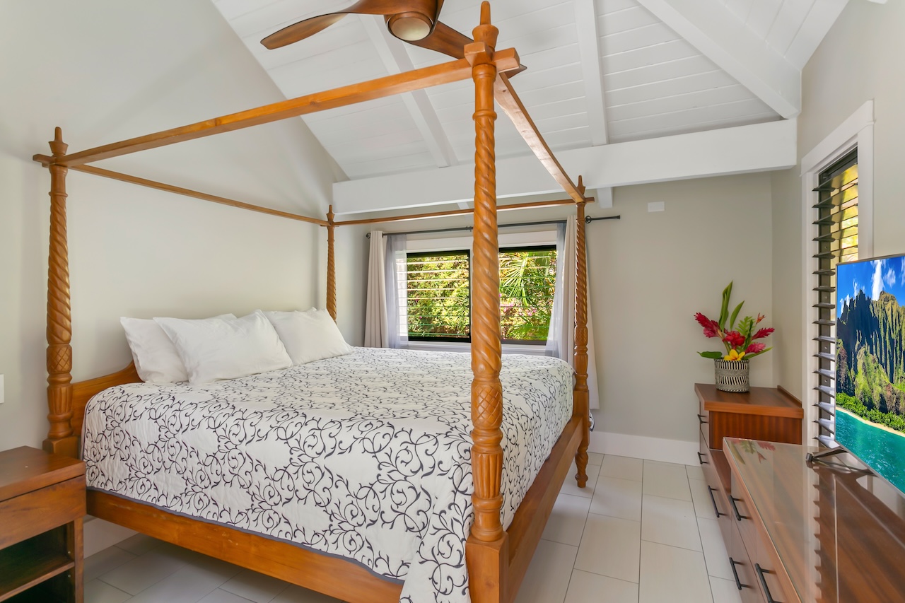 2330 Ho'ohu Road, Unit 16 Koloa, HI 96756 - Photo 18 of 29 a bed sitting in a bedroom next to a window