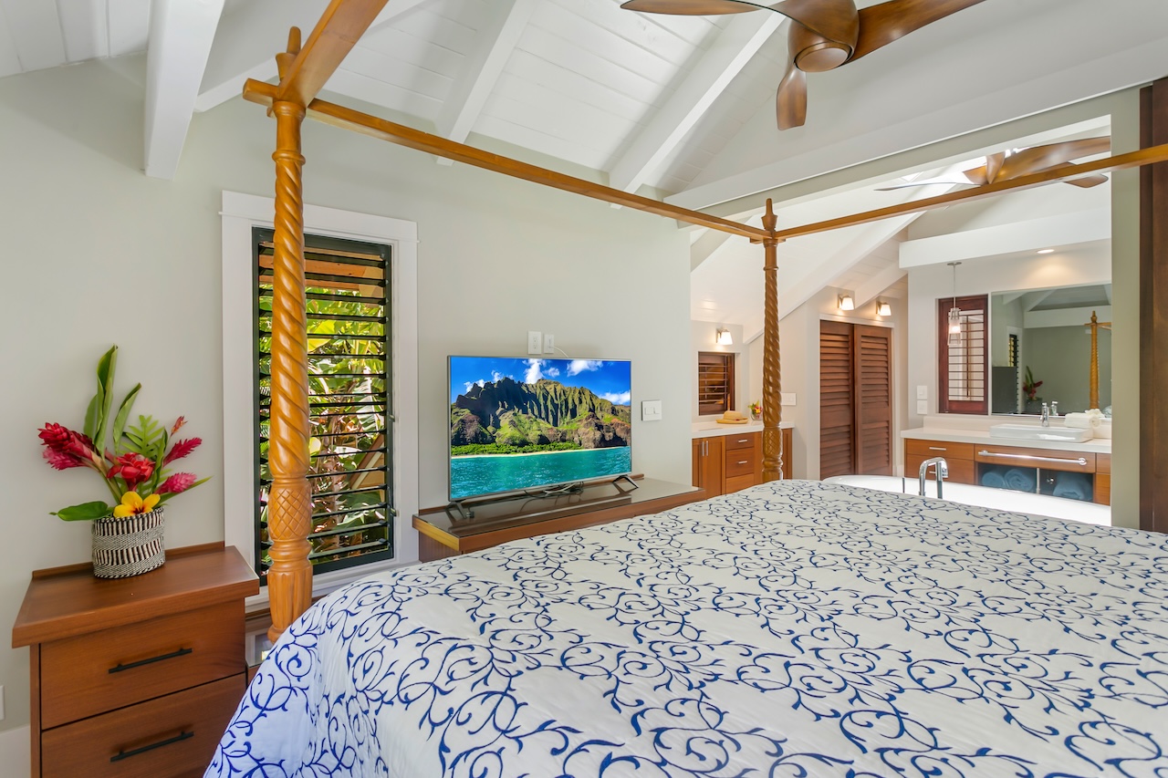 2330 Ho'ohu Road, Unit 16 Koloa, HI 96756 - Photo 19 of 29 a bedroom with a bed and a flat screen tv