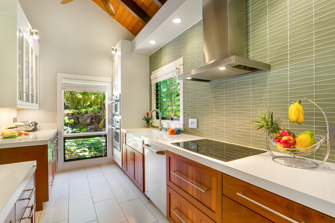 2330 Ho'ohu Road, Unit 16 Koloa, HI 96756 - Photo 4 of 29 a kitchen with stainless steel appliances kitchen island wooden cabinets a sink and a stove