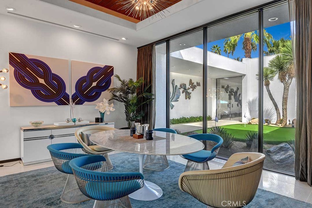 70955 Tamarisk Lane Rancho Mirage, CA 92270 - Photo 13 of 42 a living room with furniture and a large window
