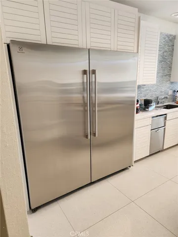 a kitchen with a refrigerator and a sink